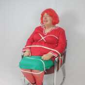 Shirley in red tied in chair
